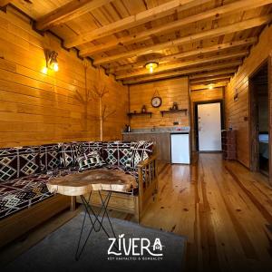 a room with a bed in a wooden room at Zivera Bungalov in Trabzon