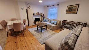 a living room with a couch and a table at Zlatibor Apartmani DM Tornik in Zlatibor