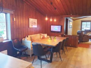 a dining room with a wooden table and chairs at Cozy cottage in Vemdalen close to the ski slopes in Vemdalen