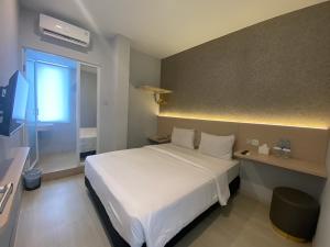 Ένα ή περισσότερα κρεβάτια σε δωμάτιο στο Swasana Hotel Medan