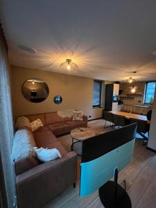 a living room with a couch and a table at Parc La Dune South Africa Lodge in Warmenhuizen