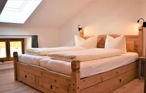 a bedroom with two beds with white pillows at Ferienwohnung Thalhammer in Bernau am Chiemsee