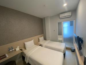 Ένα ή περισσότερα κρεβάτια σε δωμάτιο στο Swasana Hotel Medan