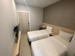 Ένα ή περισσότερα κρεβάτια σε δωμάτιο στο Swasana Hotel Medan