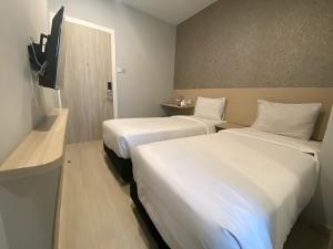 Ένα ή περισσότερα κρεβάτια σε δωμάτιο στο Swasana Hotel Medan