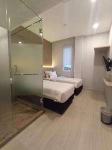 Ένα ή περισσότερα κρεβάτια σε δωμάτιο στο Swasana Hotel Medan