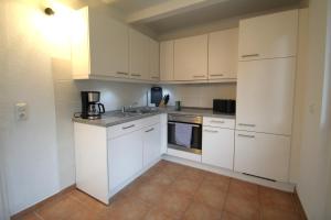 a kitchen with white cabinets and a counter top at Apartment im Zentrum von Bad Schwartau in Bad Schwartau