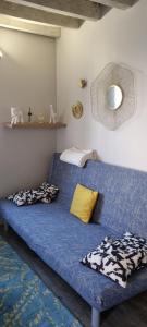 a blue bed with pillows on it in a room at La petite maison en champagne in Payns