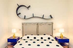 a bedroom with a bed with a heart sign on the wall at Tenuta Pianirossi in Cinigiano