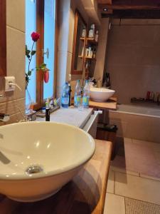 bagno con lavandino bianco e vasca di L'Écrin Savoyard a Bonne-sur-Ménoge