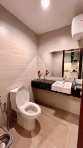 a bathroom with a toilet and a sink at West Vista Apartment JKT Modern Design w/55” TV and 40/mbps Wi-fi in Jakarta