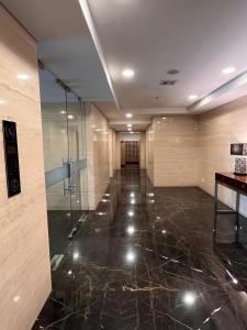a lobby with a glass elevator in a building at West Vista Apartment JKT Modern Design w/55” TV and 40/mbps Wi-fi in Jakarta +35 photos