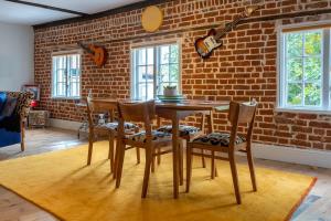 a dining room with a brick wall and a table and chairs at 1960s Inspired City Centre Apartment for 4 with Parking in Norwich