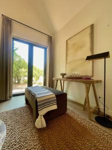 a living room with a table and a window at Mountain Cottages at Haskell Vineyard in Stellenbosch
