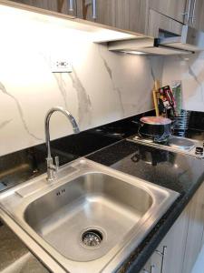 a kitchen counter with a sink in a kitchen at Scandi-Style & Organic condo Shore 3 MOA in Manila