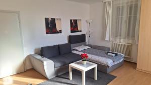 a living room with a couch and a table at Holiday Apartment 2 Villach in Villach