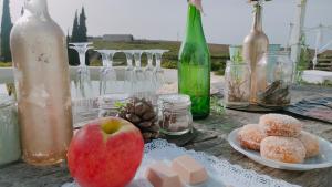 an apple sitting on a table with plates of food at Las Brujas in Sanlúcar la Mayor