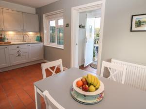 a bowl of fruit on a table in a kitchen at 8 New Houses in Wrexham