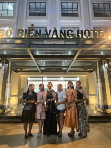 a group of women standing in front of a building at Bờ Biển Vàng Hotel in Ke Ga