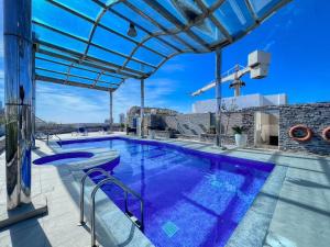 a swimming pool with a pergola on a house at Premium 1BHK near Metro station Dubai Marina & JBR in Dubai