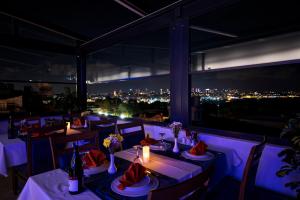 a restaurant with a view of the city at night at Antusa Design Hotel & Spa in Istanbul