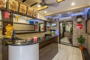 a restaurant with a counter in a room at Hotel Joy in Jaipur