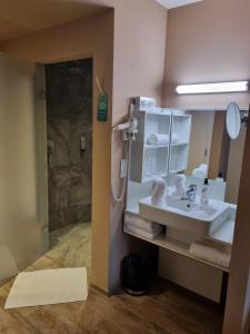 a bathroom with a sink and a shower at Cubo Sport & Art Hotel in Sankt Johann in Tirol