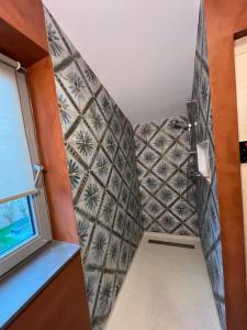 a small bathroom with a tiled wall at Parc La Dune Marrakesh Lodge in Warmenhuizen