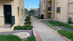 an empty alley between two buildings with plants at Entire 1 Bed, 5 mins 2 Game City, free Netflix & showmax in Gaborone