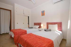 two beds in a white room with at Boreal House in Alcudia