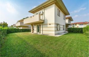 a house with a lawn in front of it at Beautiful Home In Puegnago Sul Garda in Raffa
