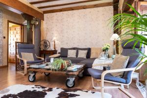 a living room with a couch and chairs and a table at Abad casa Siguenza 250m2 vivienda y exterior in Sigüenza