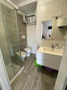 a bathroom with a shower and a sink and a toilet at Specchio Marino in Ponza