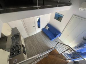 an overhead view of a living room with a blue couch at Specchio Marino in Ponza