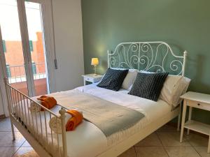 a bedroom with a bed with an iron headboard at LA CASA DEI FIORI - S. LORENZO in Rome
