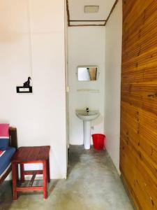 a bathroom with a sink and a table and a toilet at Walkers hostel in Trincomalee