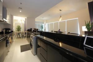 a large kitchen with a washer and dryer in it at Panoramic Marina View 2BR Suite Damac Heights in Dubai