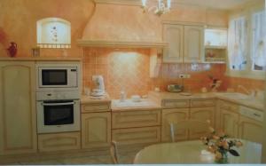 una cocina con electrodomésticos blancos y una mesa. en chez Patrice et Gilda, en Albi