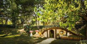 a small house with an umbrella in a yard at Camping Lanterna Premium Resort - Vacansoleil Maeva in Poreč