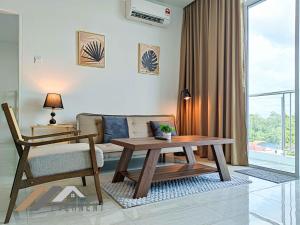 a living room with a couch and a table at Stirling Suites by Evernent in Miri