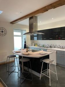 a kitchen with a large island with bar stools at Loft de charme en centre-ville in Pau