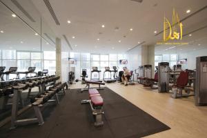 a gym with treadmills and machines in a room at Panoramic Marina View 2BR Suite Damac Heights in Dubai