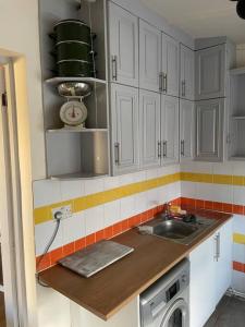 a kitchen with white cabinets and a sink at Heath Farm cottage in Newport