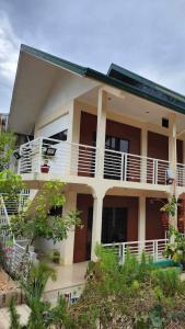 a large building with a balcony on the side of it at Flores Garden Hotel in Coron