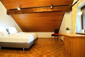 a bedroom with a bed and a wooden headboard at Amadeus Black Forest Mountain in Todtmoos
