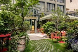 La Fantaisie في باريس: حديقة بها طاولات وكراسي في مبنى