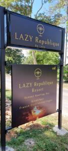 a sign for a park with a sign for la ray repulse at Lazy Republique in Ko Chang