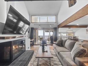 a living room with a couch and a fireplace at VP211 Village Point condo in Copper Mountain