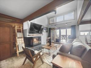 a living room with a couch and a fireplace at VP211 Village Point condo in Copper Mountain