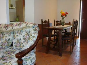 a living room with a couch and a table and chairs at Affitta camere Il Ruscello in Scheggino